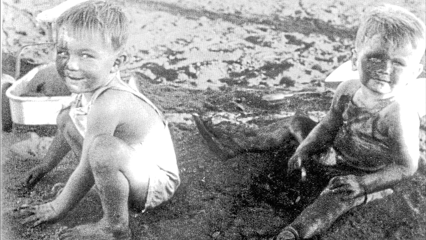 Elaine's neighbourhood pals Philip Noble, left, and Ross Munroe, playing in asbestos pit, died in their thirties