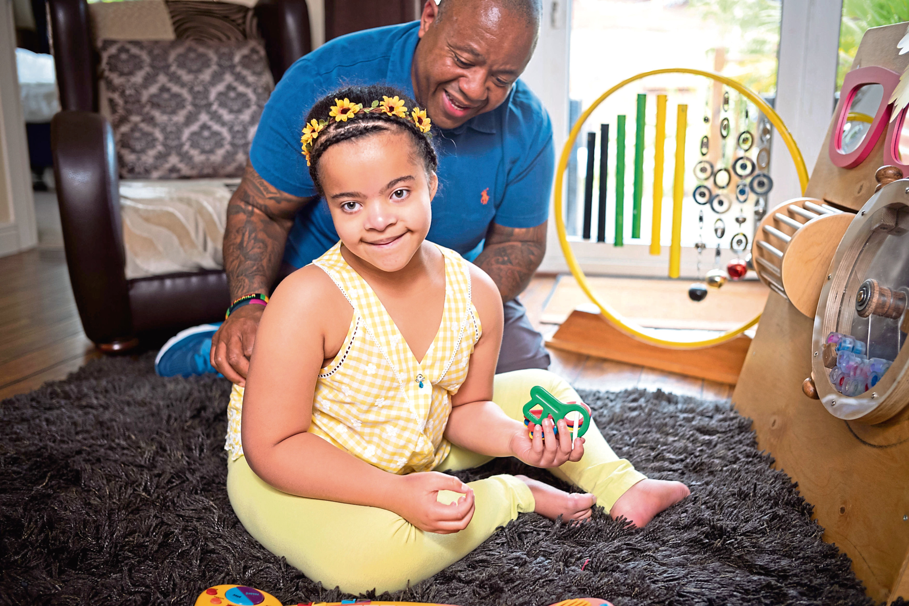 11-year-old Faith Soloman who has Kleefstra Syndrome, with her dad Gary (London Corporate Photography/Jeans for Genes/PA)