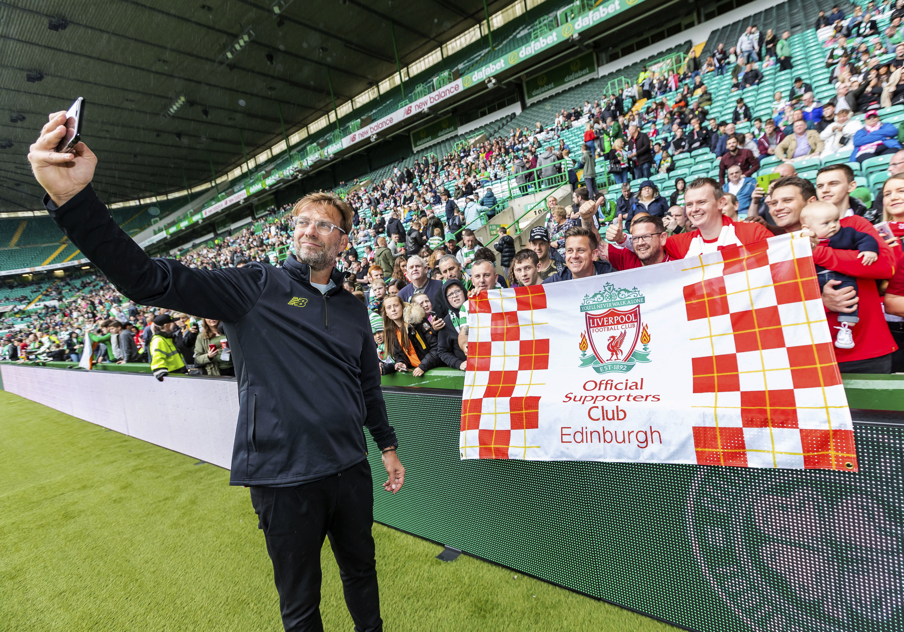 Jurgen Klopp was the centre of attention at Celtic Park yesterday, and obliged these fans with a selfie (SNS Group / Roddy Scott)