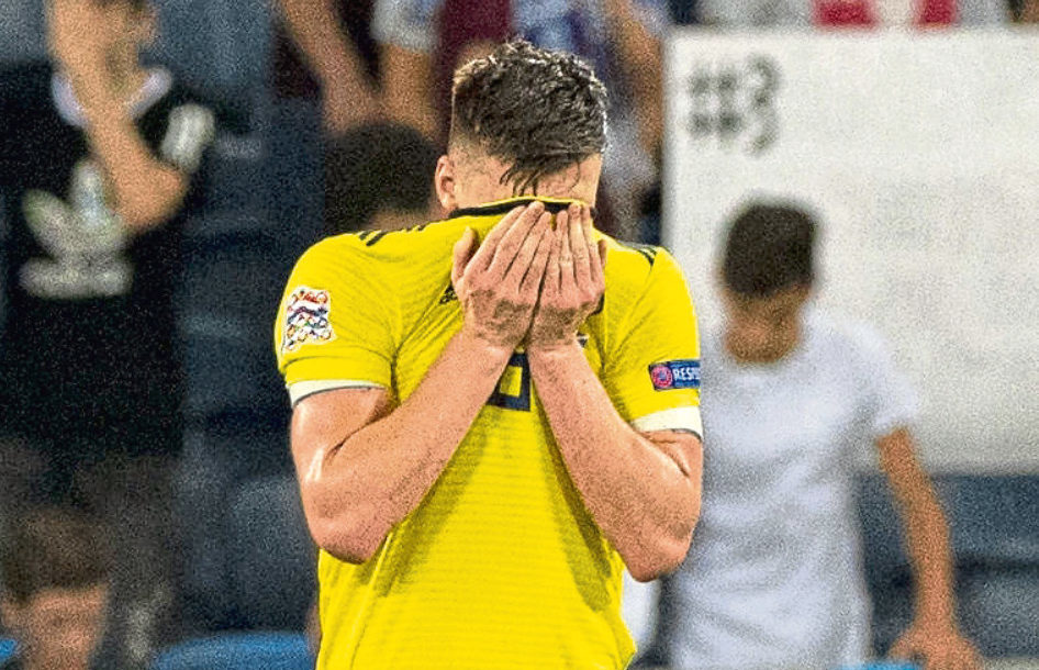 Kieran Tierney looks dejected after scoring an own goal in the Israel game (SNS Group)