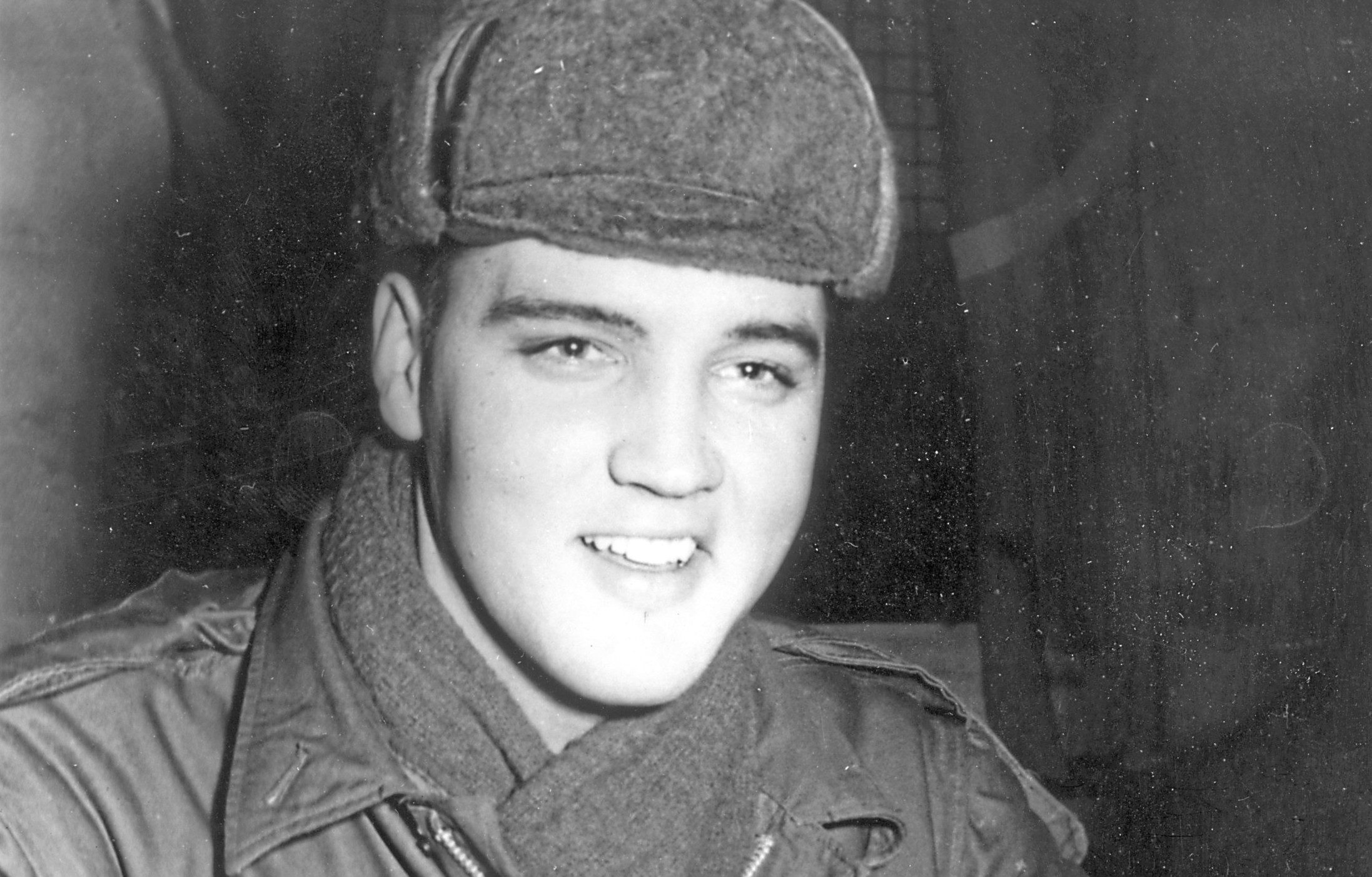 17th December 1958:  US rock 'n' roll singer Elvis Presley (1935 - 1977) in military uniform during his stint as a US serviceman at the Grafenwoehr exercise camp, Germany.  (Keystone/Getty Images)