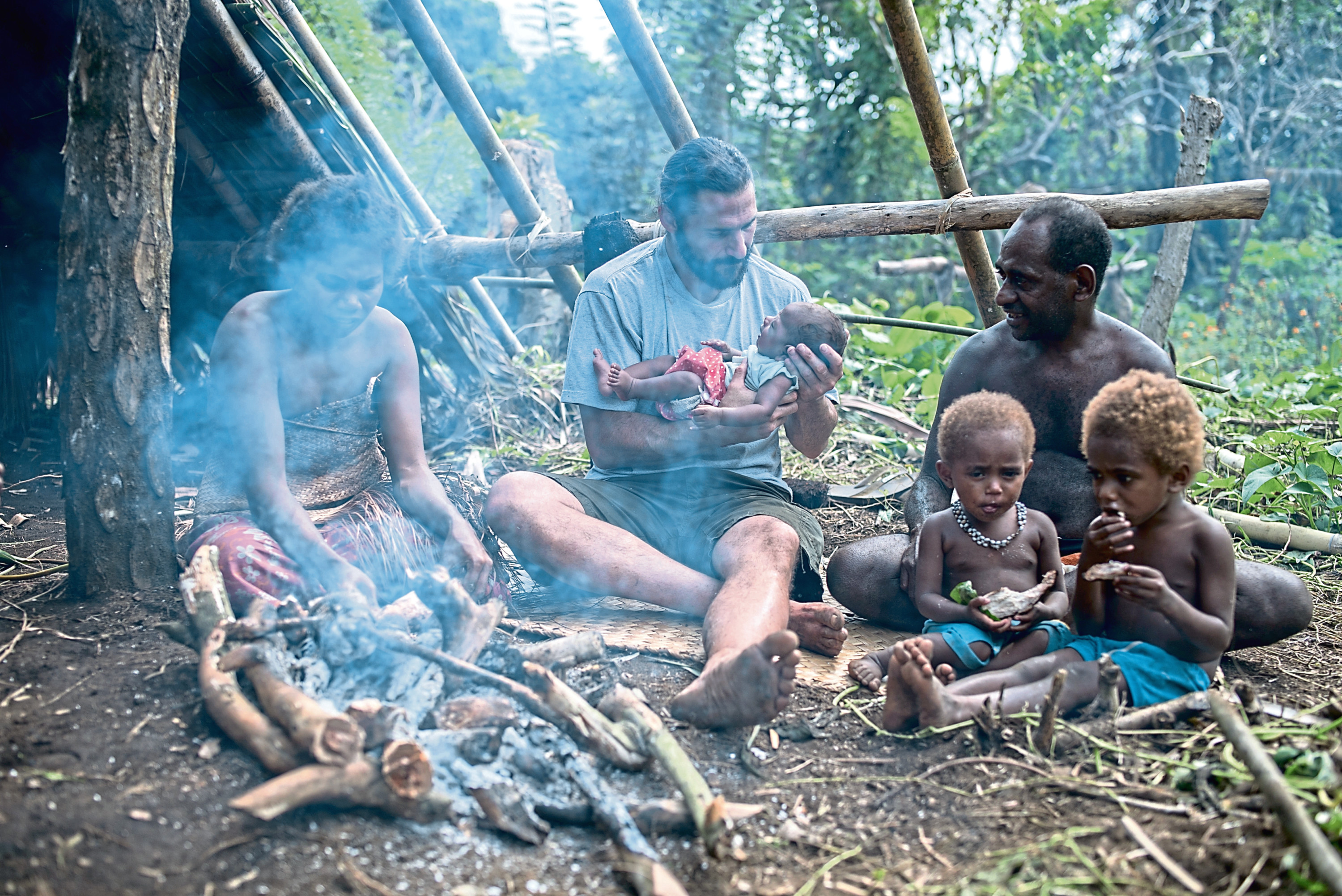 Vanuatu - Hazen holding a newborn child alongside the Salkon Chief Atkins family. (National Geographic/Jimmy Cape)