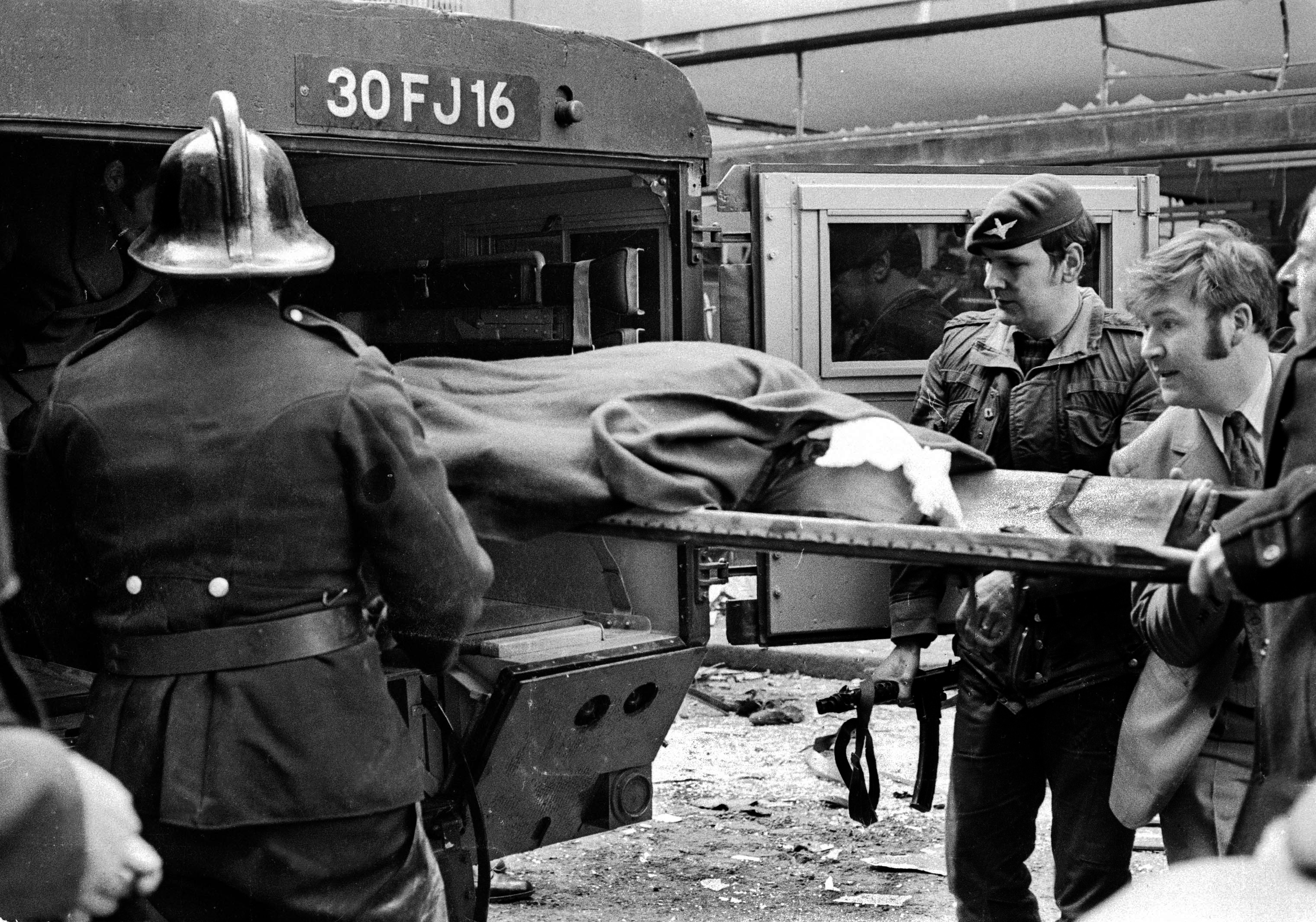 Explosion in Donegall Street, Belfast, in which 7 people died and 130 were injured. Four of the dead were bin men. No warning bomb was in a car. One of injured is taken away in a British Army ambulance. (Victor Patterson)