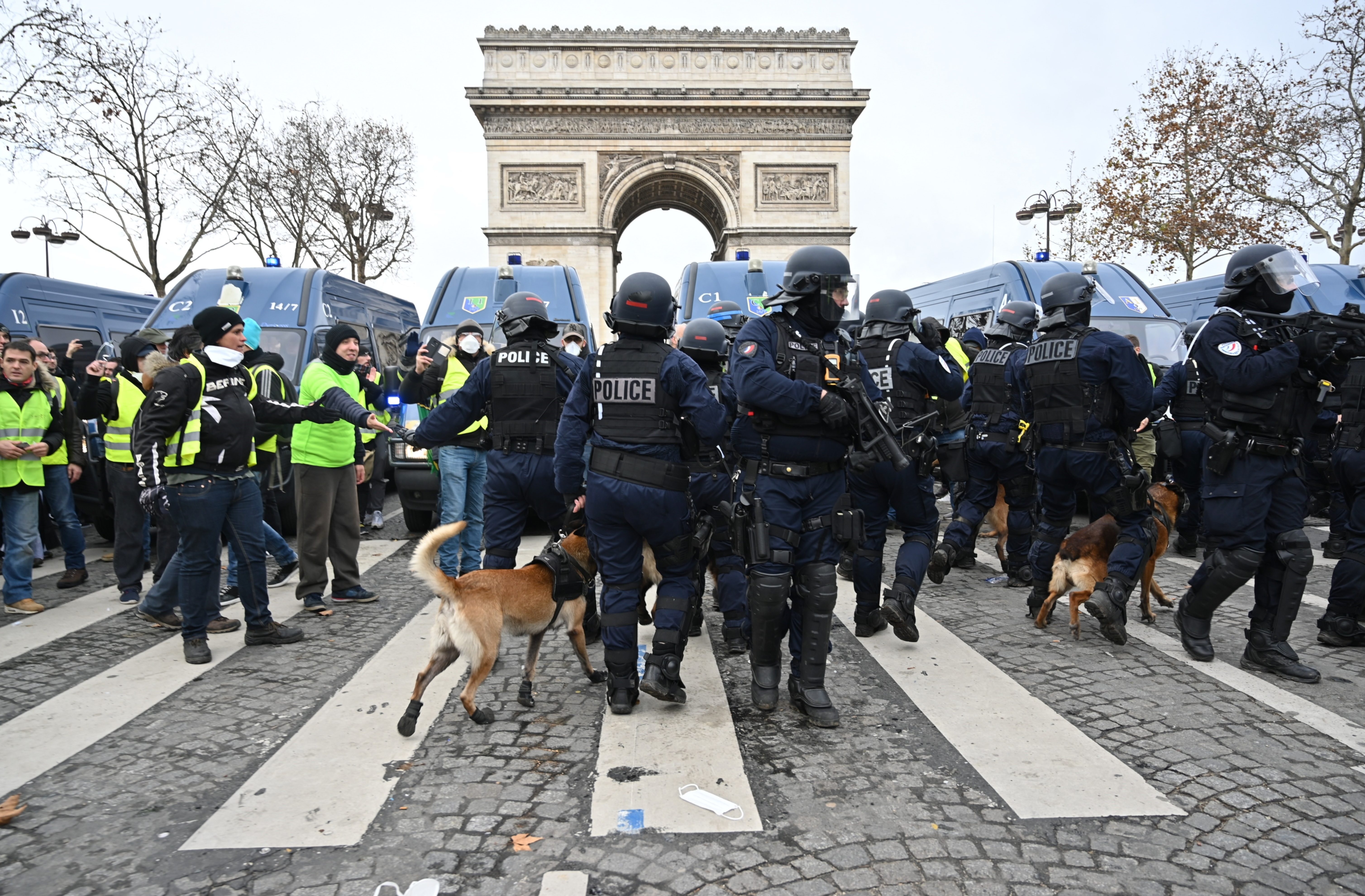 French riot police at the Arc de Triomphe break up protests against rising oil prices yesterday (Mustafa Yalcin/Anadolu Agency/Getty Images)