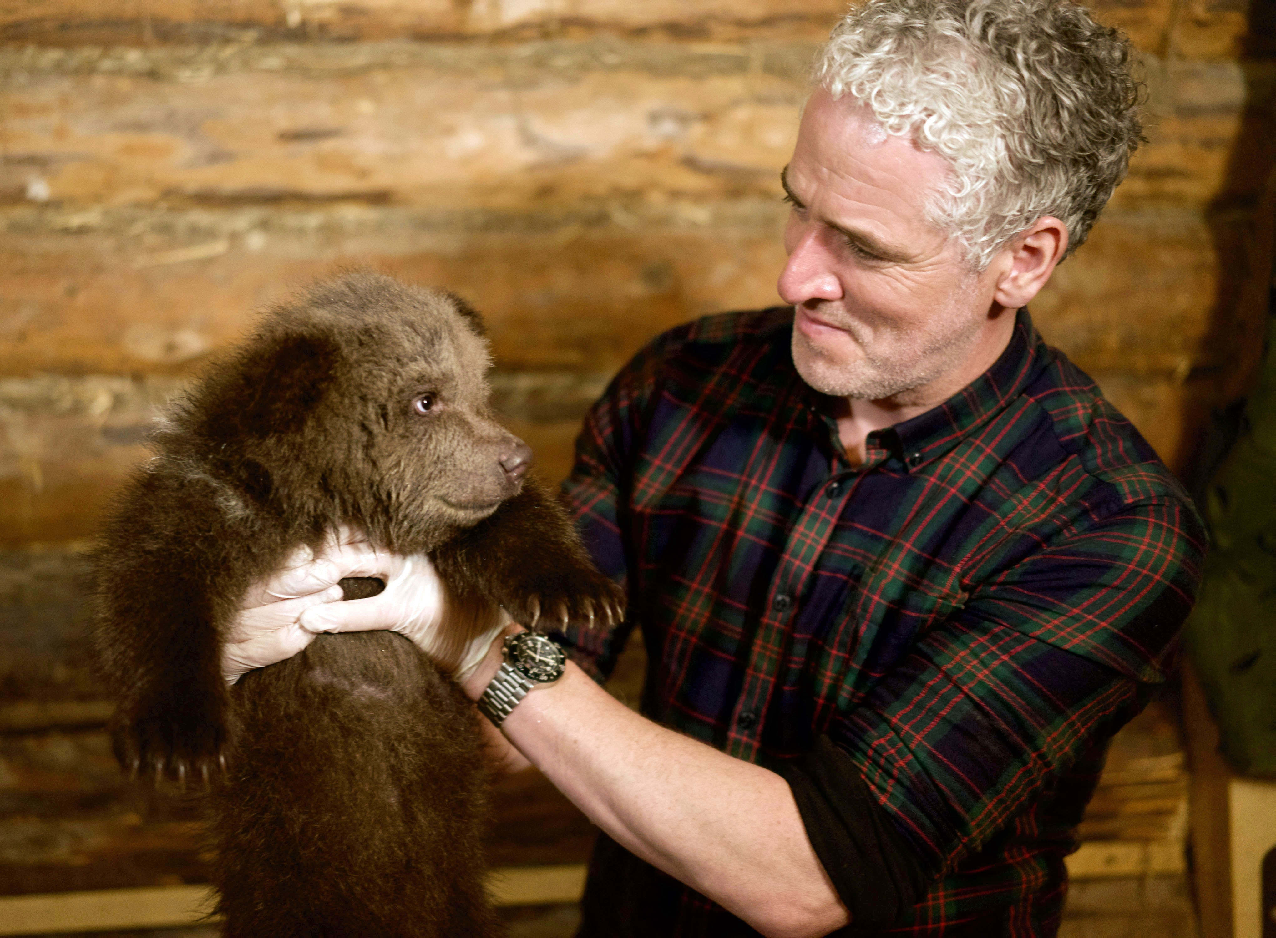 Gordon Buchanan helps to bath an eight-week-old Russian bear cub at the Orphaned Bear Rescue Centre, Bubonitsy, Russia in his new TV series. (Anwar Mamon)