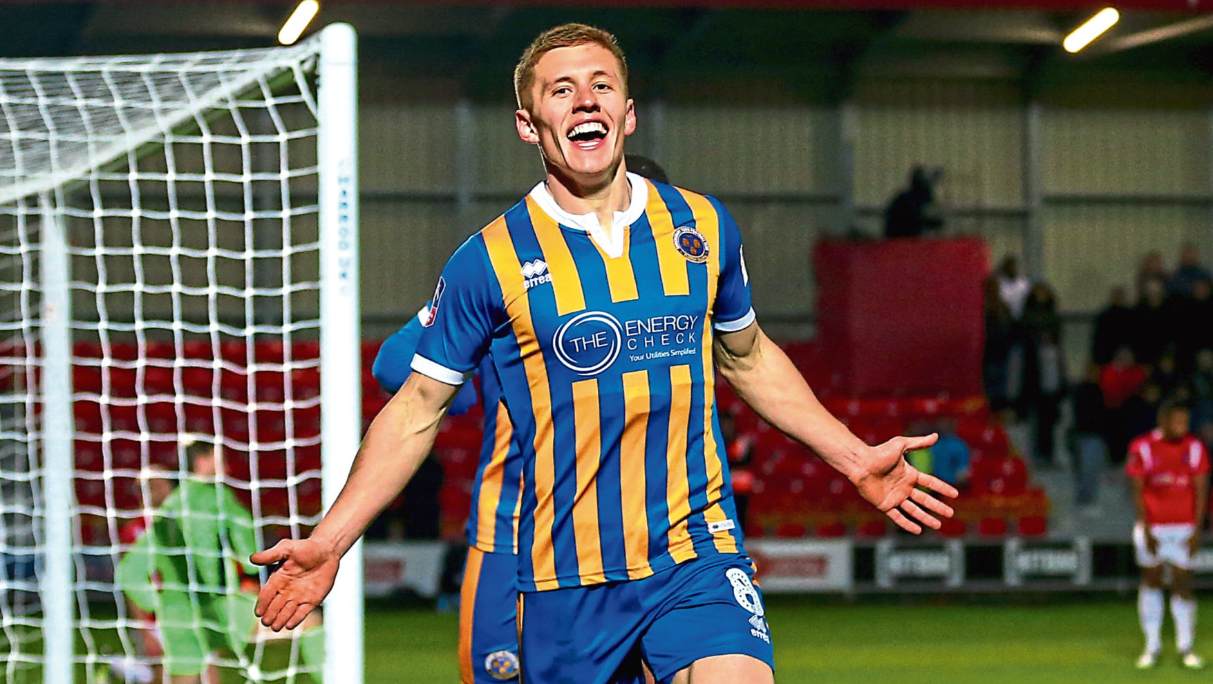 Greg Docherty celebrates one of several goals he's scored on loan at Shrewsbury (Robbie Jay Barratt - AMA/Getty Images)