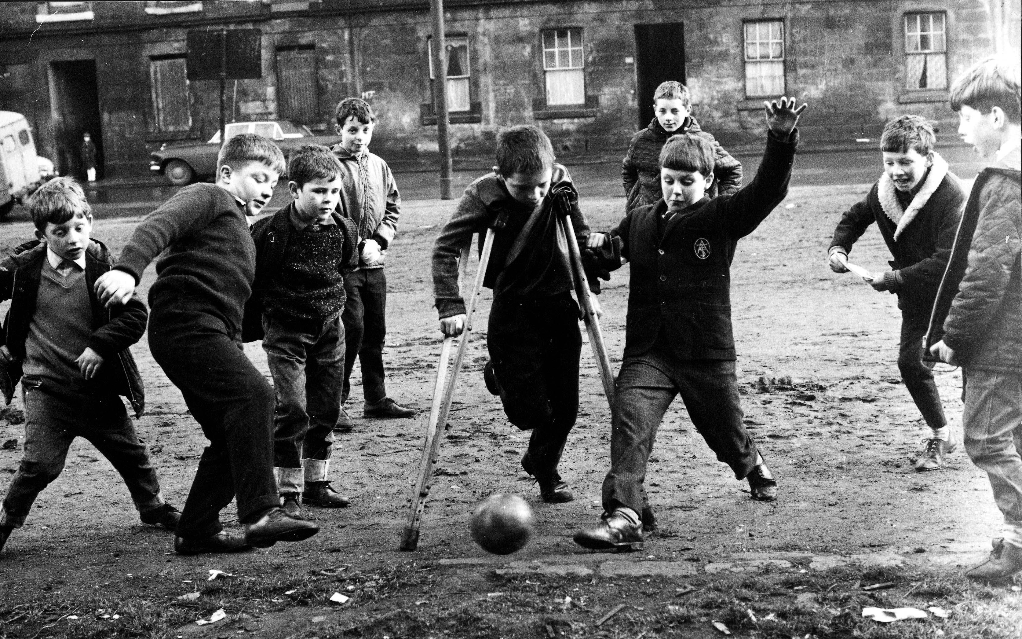 Children kick a football around in the Gorbals, Glasgow in 1967 (Popperfoto/Getty Images)