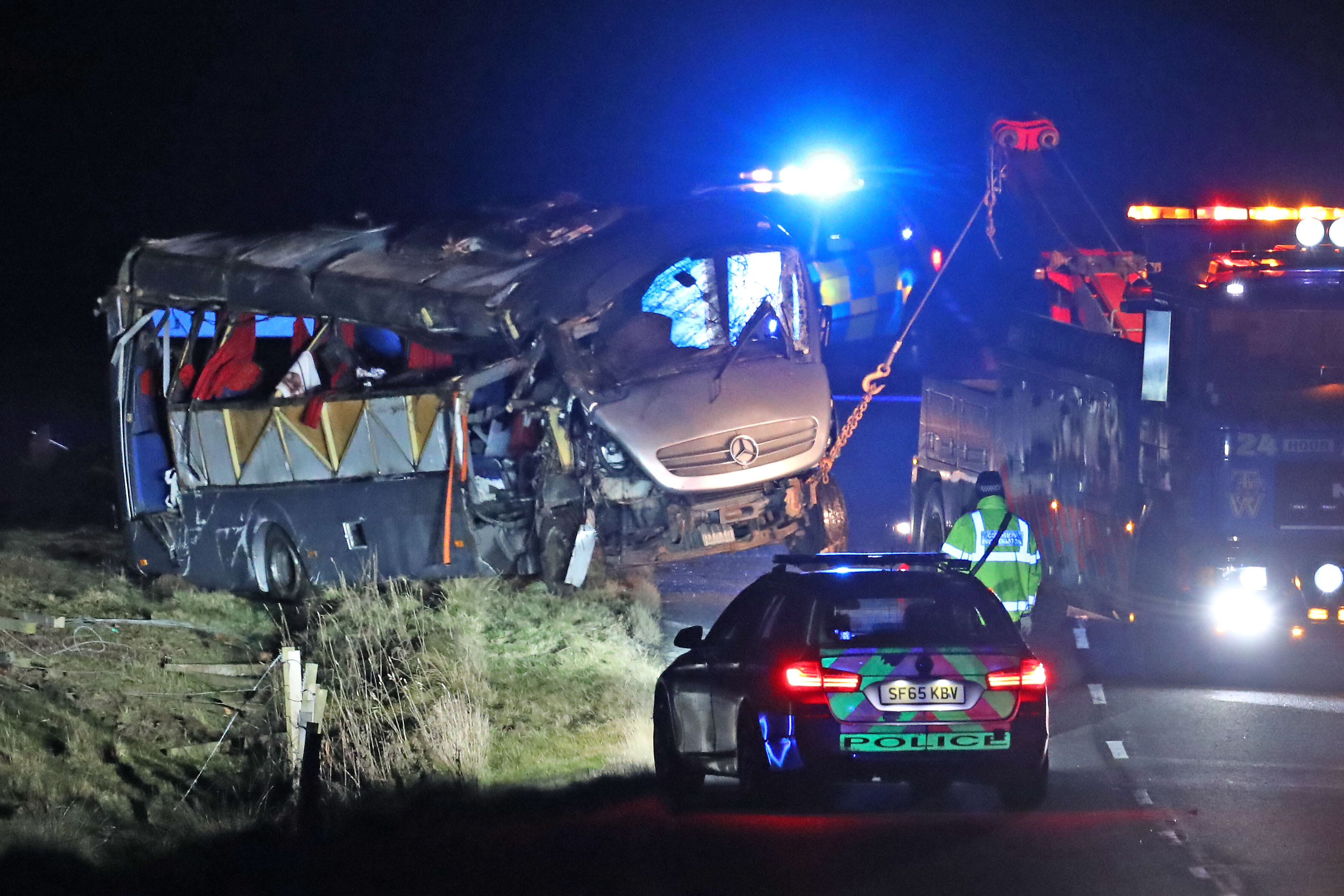 A minibus is pulled out of a field on the A6089, between Carfraemill and Gordon (Andrew Milligan/PA Wire)