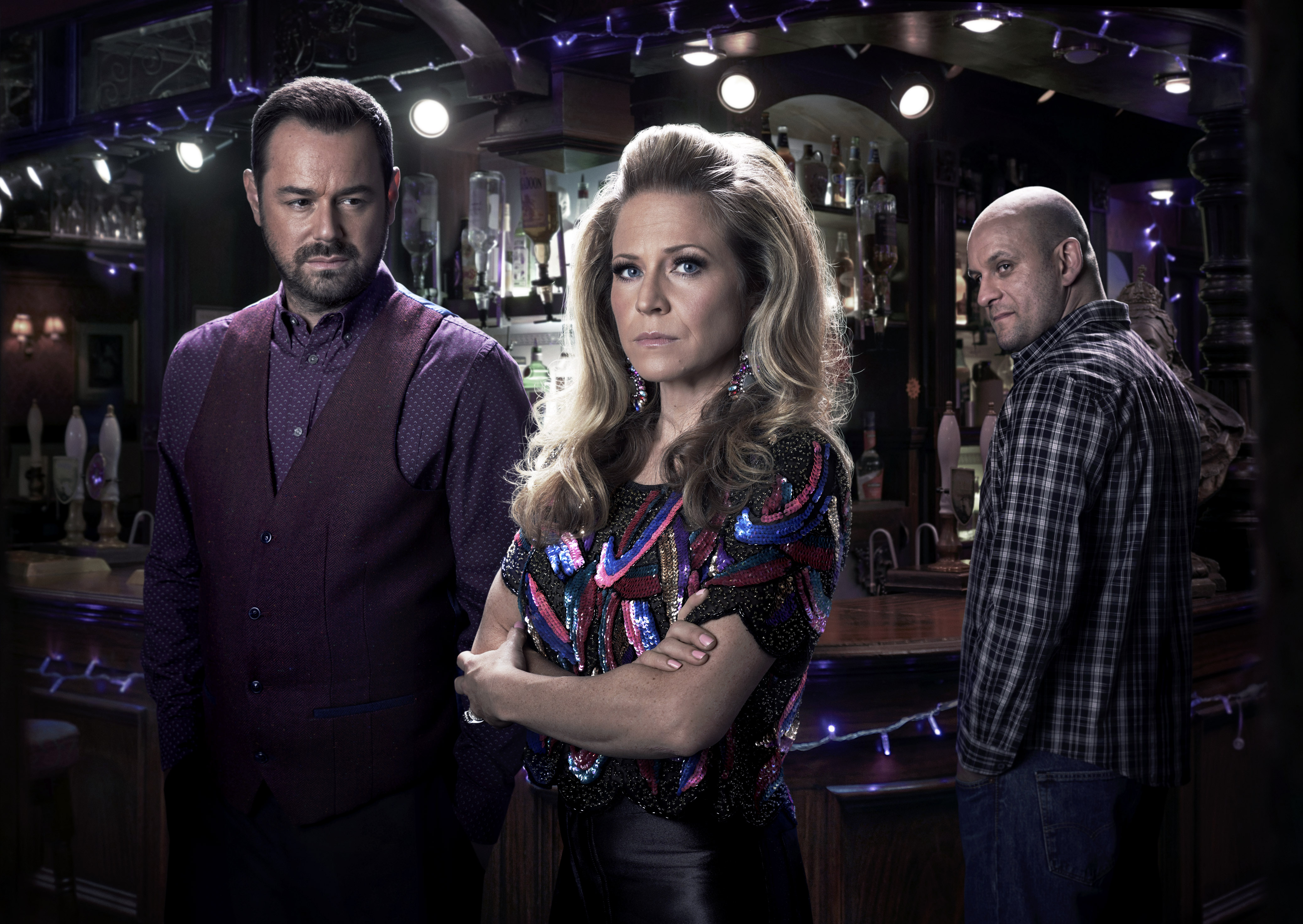 Ricky Champ, right, keeps an eye on Danny Dyer’s Mick and Kellie Bright as Linda in EastEnders (BBC /Kieron McCarron)