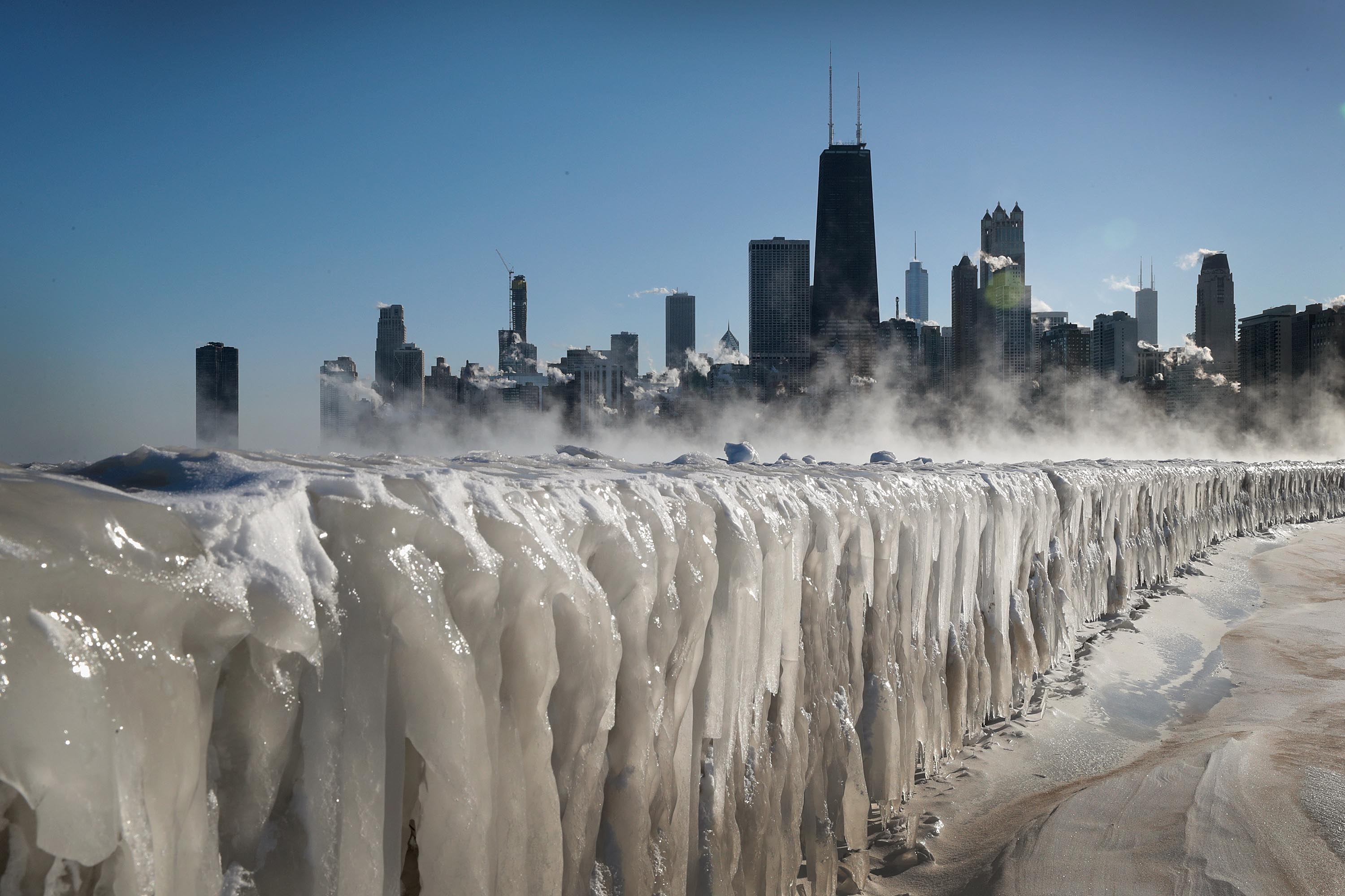 Ice covers the Lake Michigan shorelinein Chicago, Illinois. Businesses and schools have closed, Amtrak has suspended service into the city, more than a thousand flights have been cancelled and mail delivery has been suspended as the city copes with record-setting low temperatures. (Scott Olson/Getty Images)