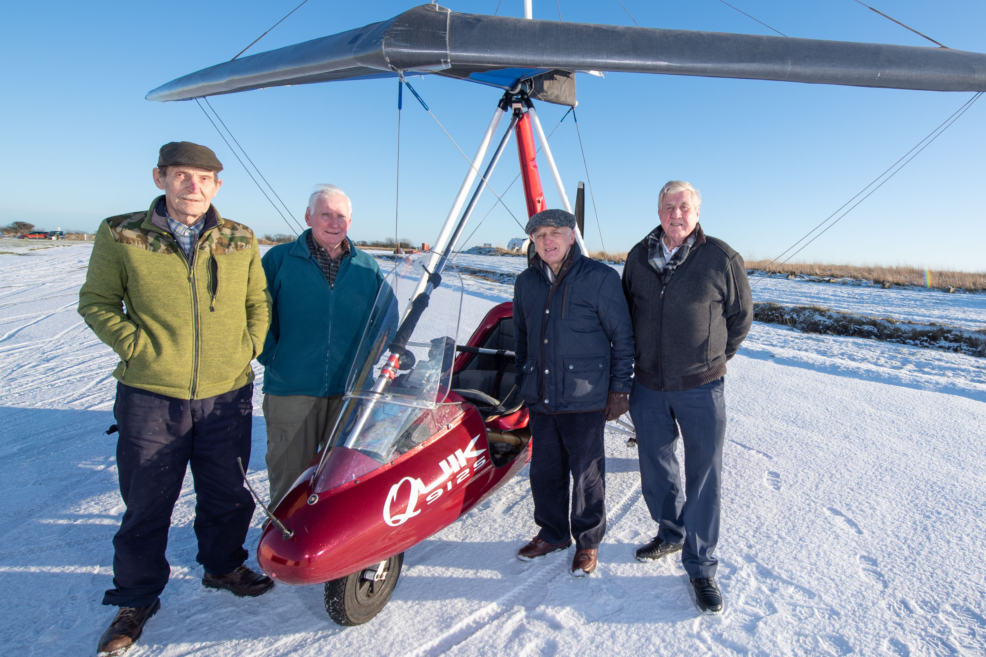 Pilots Jim Bolton, 78, Bob Shewan, 80, Alfie Thomson and Peter Bailey, both 81, with a microlight at Longside Airfield near Peterhead