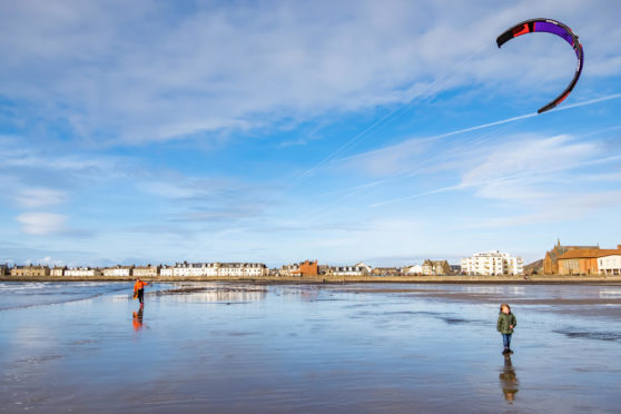 Troon, 16th February, 2019. Kitesurfers at South Beach on a sunny afternoon.