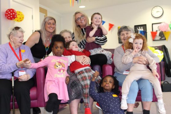 Nursery staff, Janine Al-Gailani (l) and Kathryn O'Neill, with the children and care home residents.