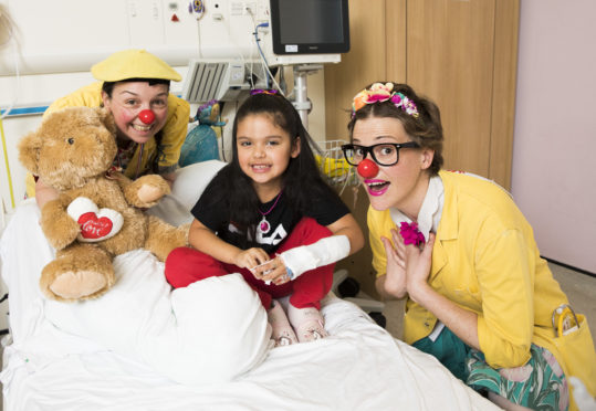 Clowndoctors Dr Wallop (Diane Thornton) & Dr Maybee (Suzie Ferguson) with patient Tamara Demel, six, at the Glasgow Royal Hospital for Children