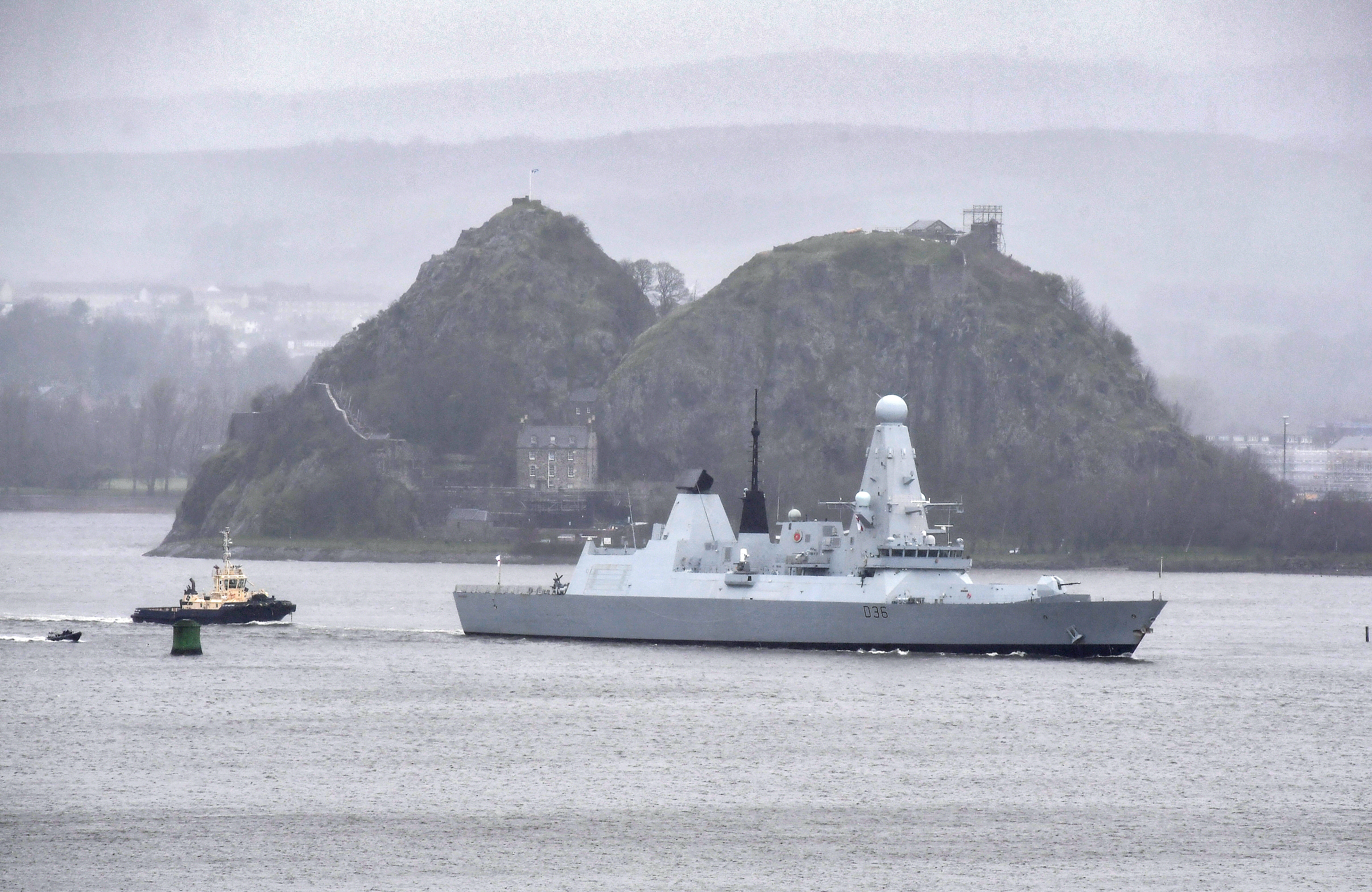 HMS Defender escorted by tugs past Dumbarton Rock