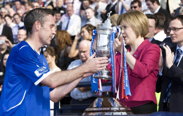 Davie Weir receives the Scottish Cup in 2009 from Nicola Sturgeon, then the Deputy First Minister