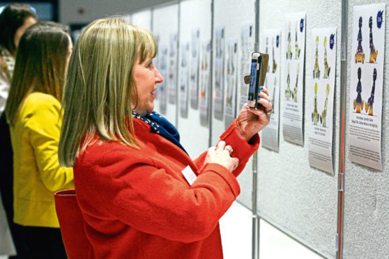 Visitors admire the Oor Wullie Big Bucket Trail statue designs.