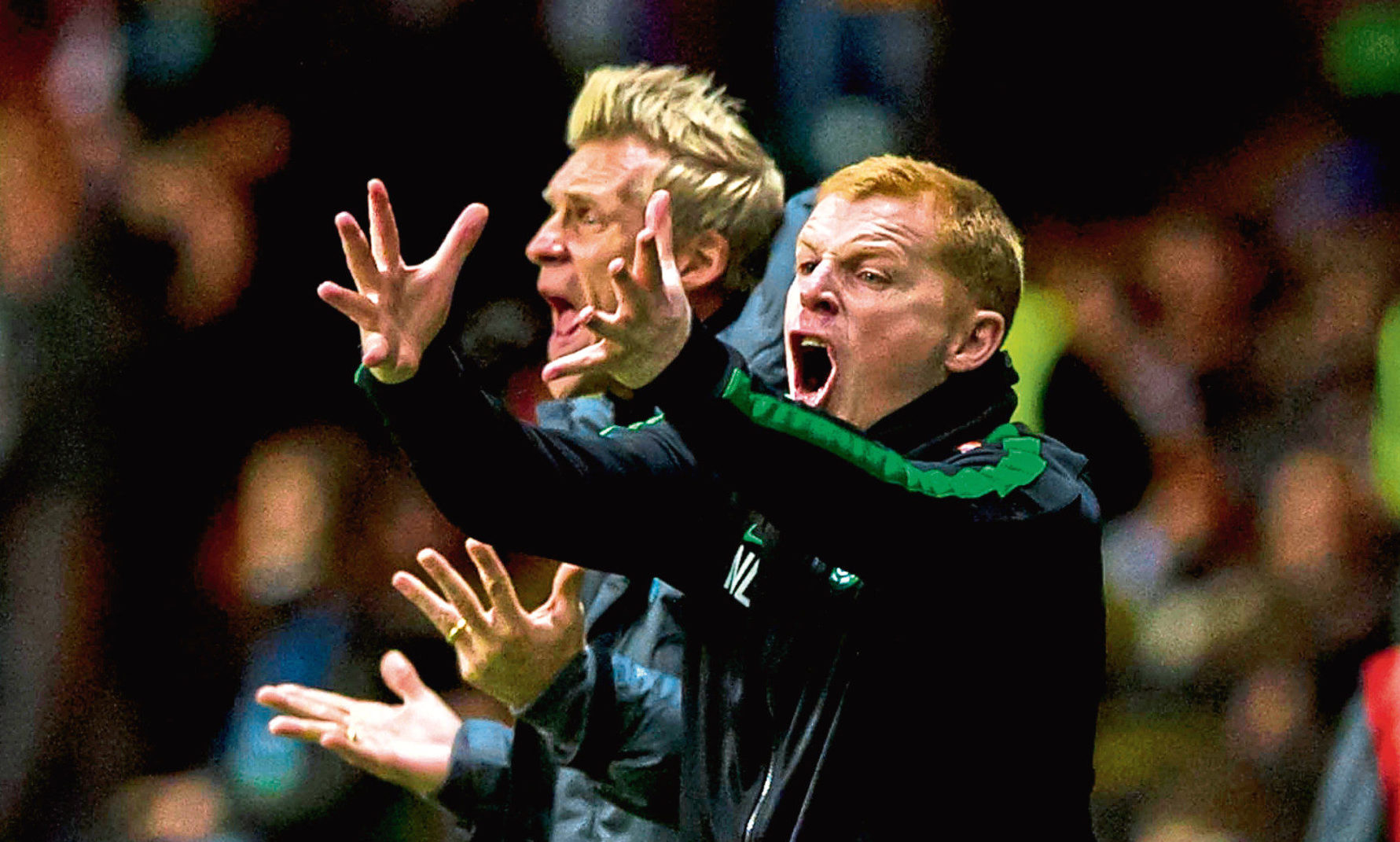 Celtic manager Neil Lennon (right) and assistant Johan Mjallby urge their team on from the sidelines, 2013
