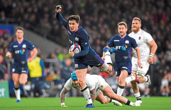 Sam Johnson of Scotland evades Jack Nowell of England as he breaks away to score their sixth try