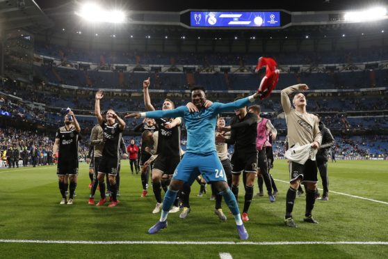 Ajax players celebrate a famous win
