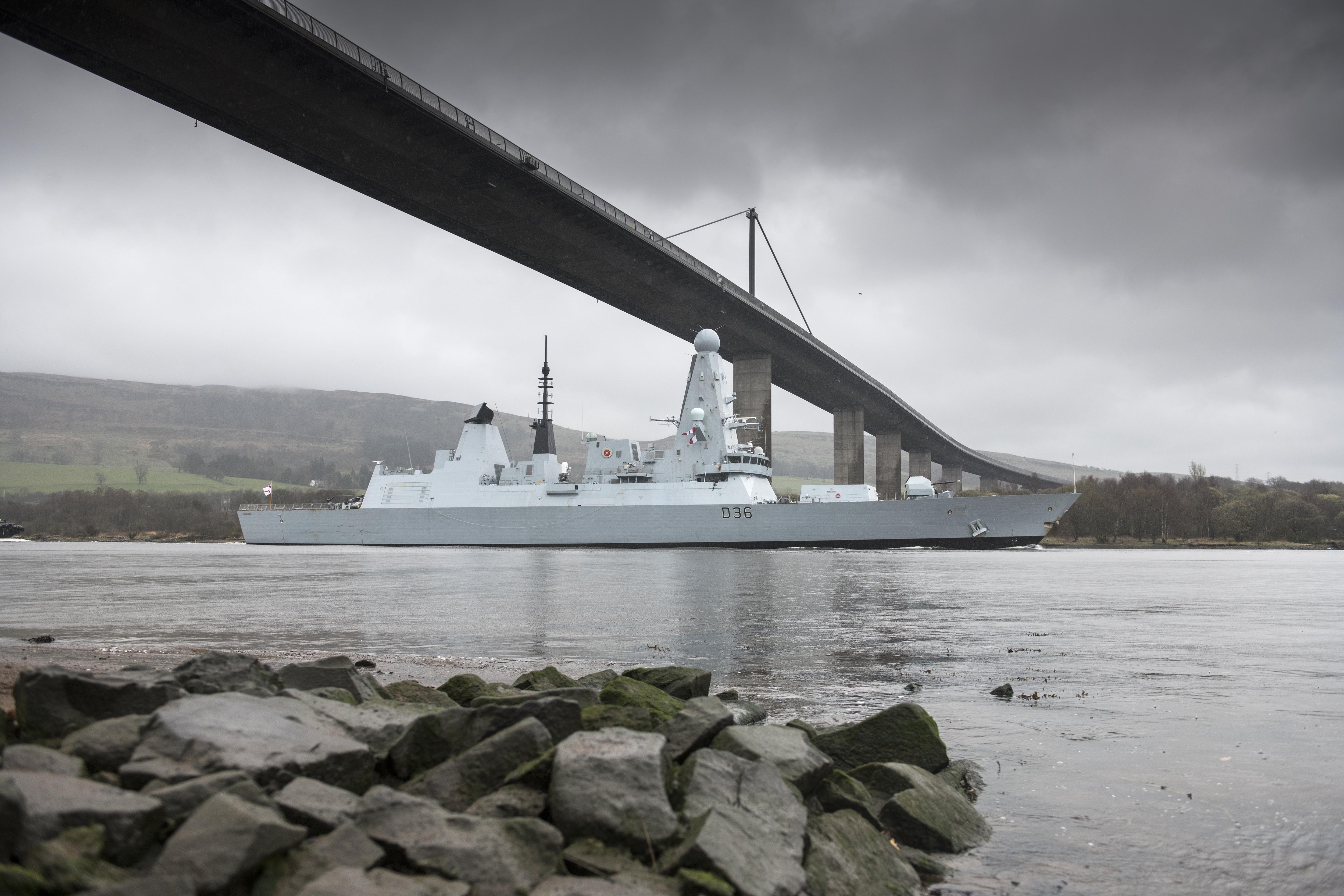HMS Defender, a Royal Navy Type 45 Destroyer built in Clyde shipyard in 2013, passes under the Erskine Bridge on her return to Glasgow. The ship is berthed at King George V Dock, around a mile away from where it was built and launched, and is open to visitors all weekend