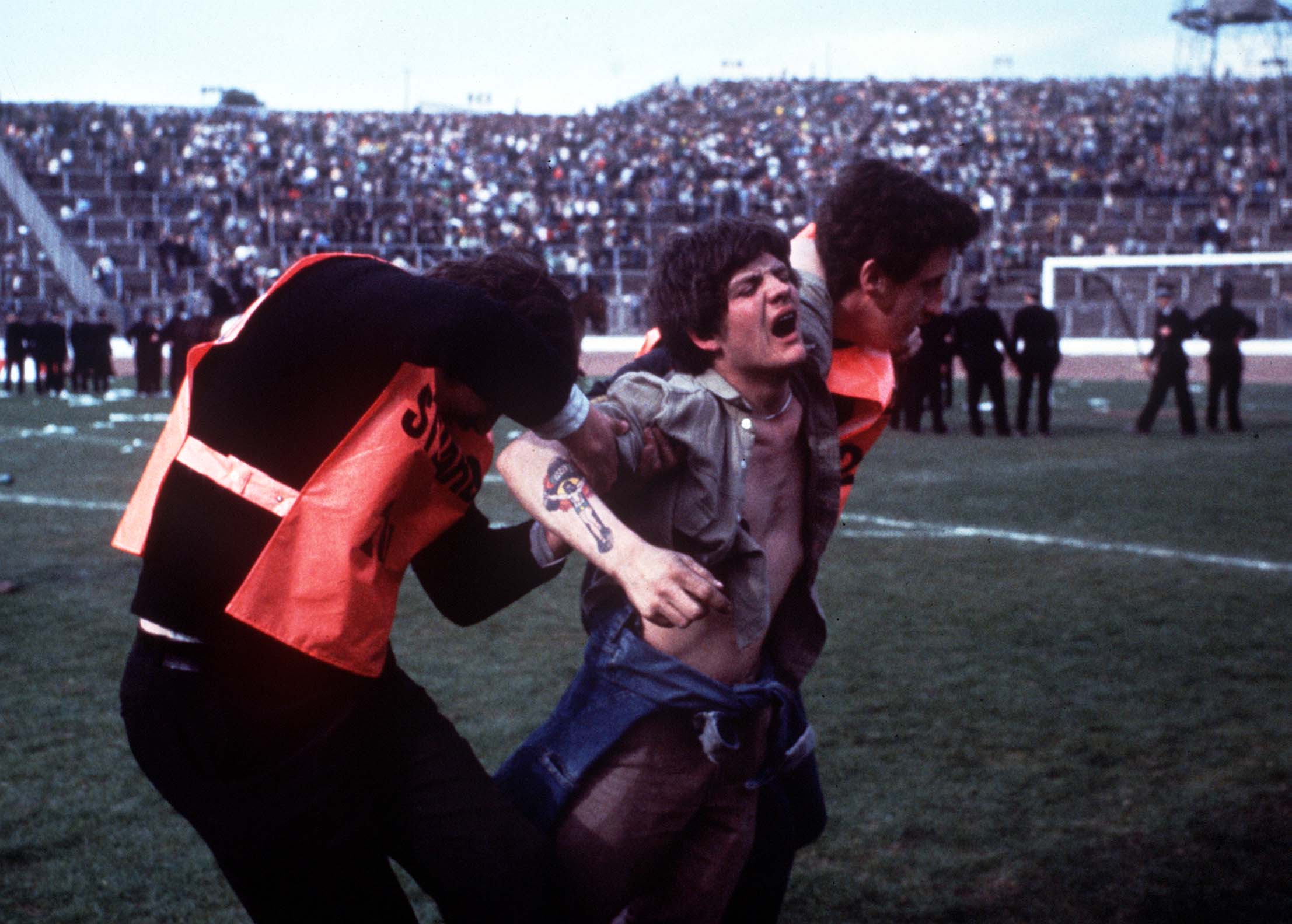 Stewards remove a fan during the Scottish Cup Final at Hampden in May 1980