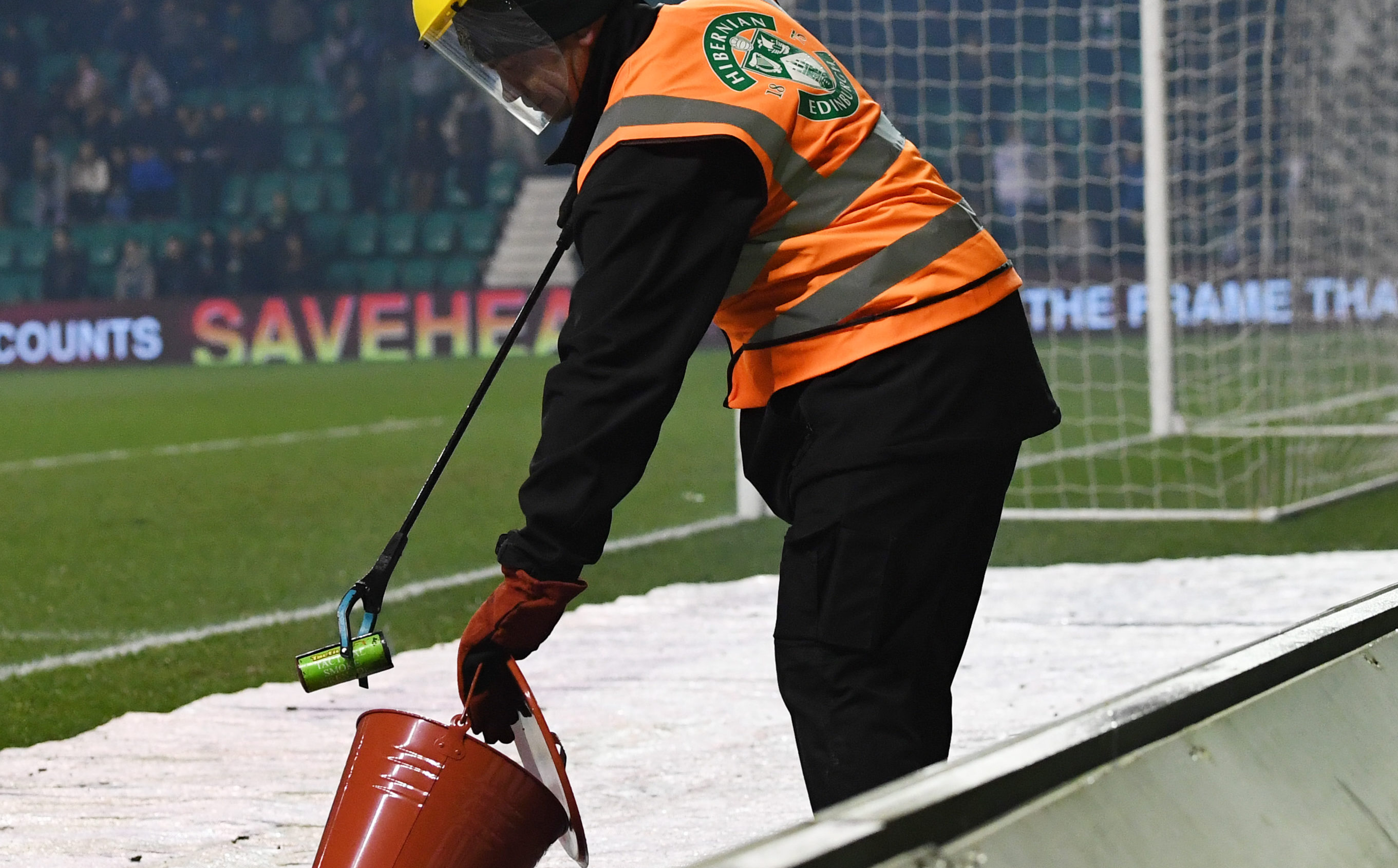 A flare is doused 
at Hibs-Celtic cup tie last month