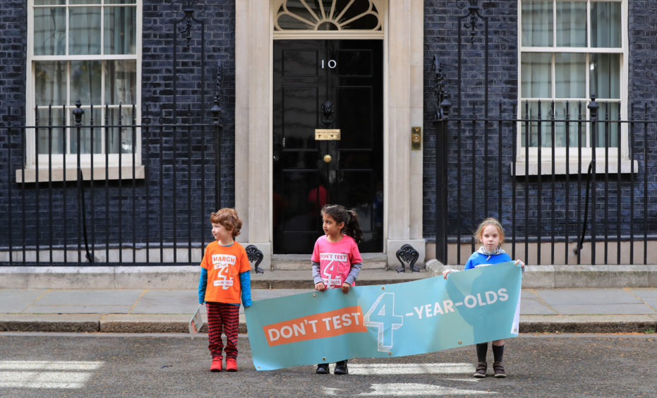 Alex Harrison (left), Safa Patel and Isla Tart outside 10 Downing Street as they prepare to deliver a petition calling for an end to tests in Reception class