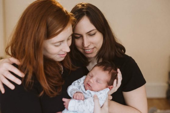 Same-sex couple Sara and Hanna Moy with their baby, Struan.
