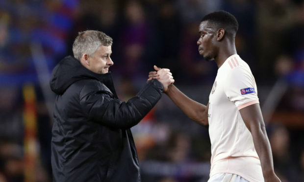 Manchester United coach Ole Gunnar Solskjaer with Paul Pogba