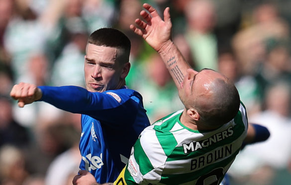 Rangers' Ryan Kent (left) and Celtic's Scott Brown clash