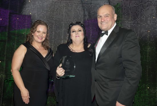 Marion Scott (centre) with her award for Campaign of the Year
