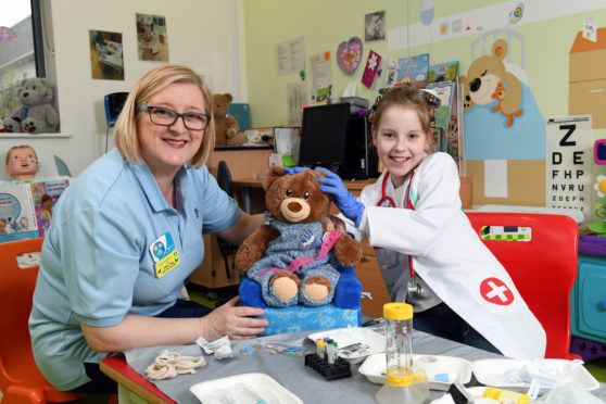 Pictured is Hayley Pollock aged 10 with nurse Jane Craig in the Teddy Hospital at the Royal hospital for sick children in Glasgow.