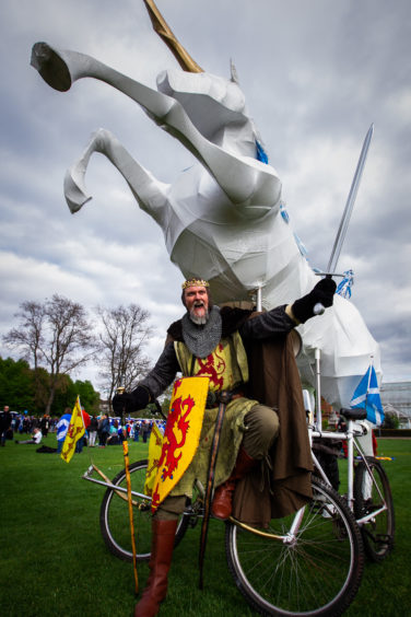 Frank Boyd (from Alexandria) aka "Robert The Bruce", with a giant "Independence Unicorn Bicycle", in Glasgow Green