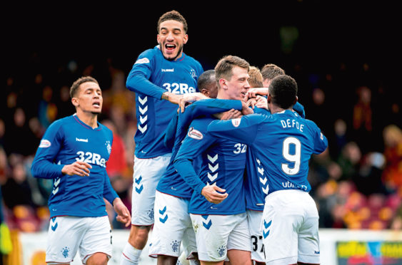 Connor Goldson joins his Rangers team-mates for a goal celebration