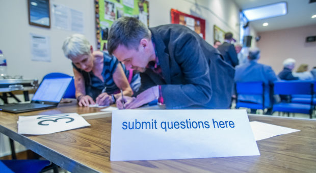 Organisers collate the questions asked by the audience at a hustings in Livingston