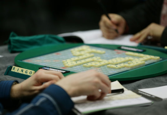 Competitors taking part in a Scrabble Champions Tournament