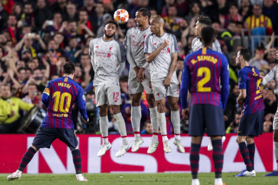 Lionel Messi’s stunning free-kick goes over the Liverpool wall en route to the net to put Barca three up