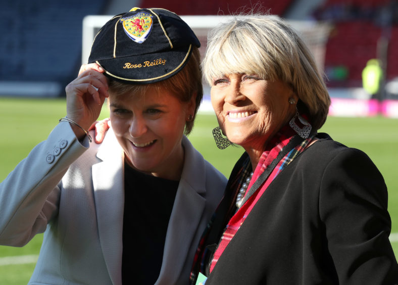 Nicola Sturgeon tries on Rose Reilly's cap
