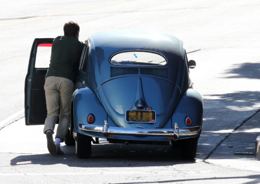 Ewan McGregor pushes his broken-down 1954 Volkswagen Beetle to the kerb in LA earlier this year