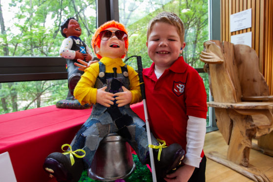 Bo Cox (8) , with the Royal Blind School's statue.