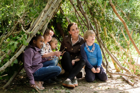 The Duchess of Cambridge making a shelter with local children and Blue Peter presenter Lindsey Russell at Westminster City Council's recreation ground.
