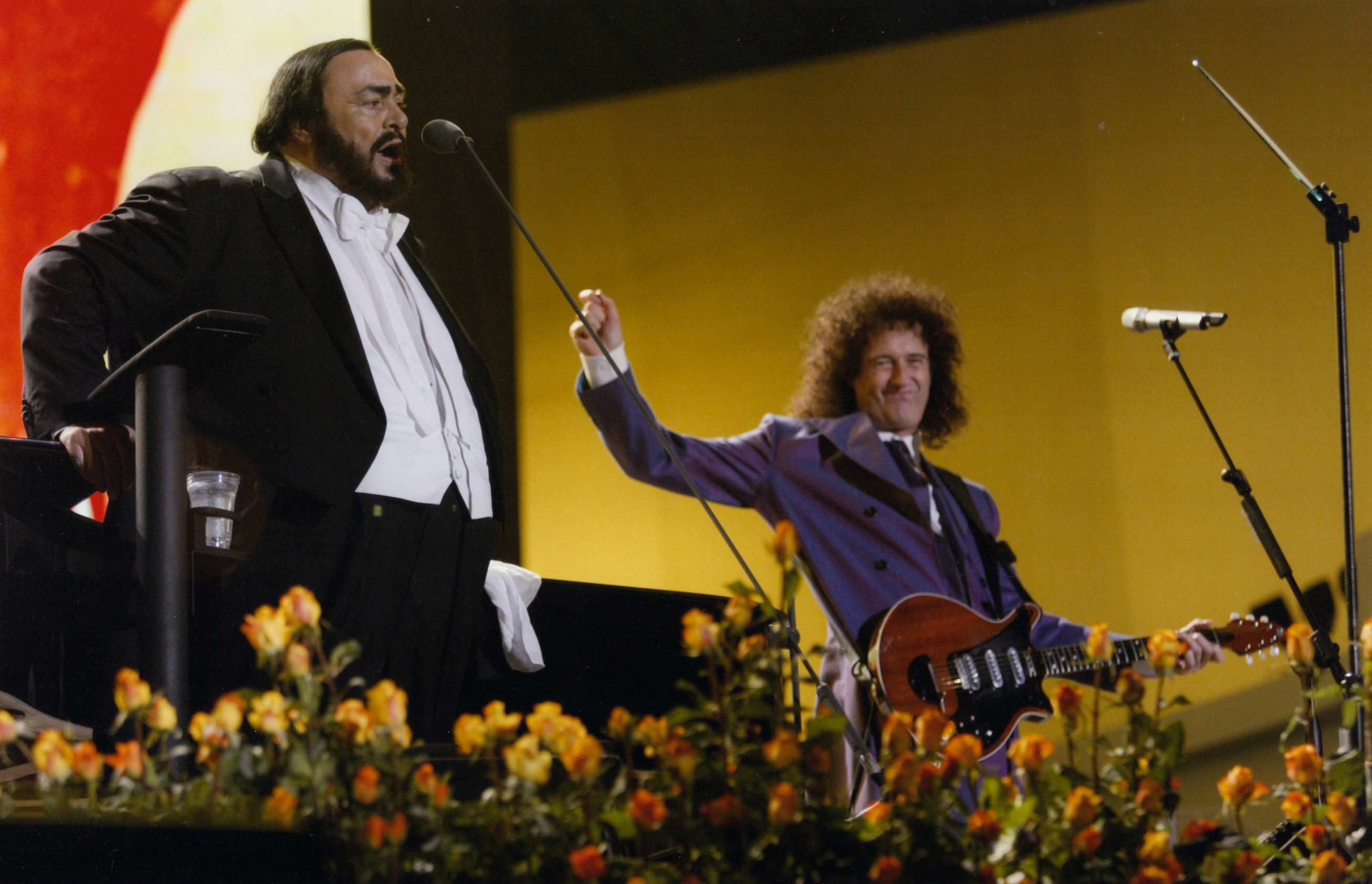 A rare duet of Pavarotti (left) and Brian May from the Pavarotti And Friends benefit concerts