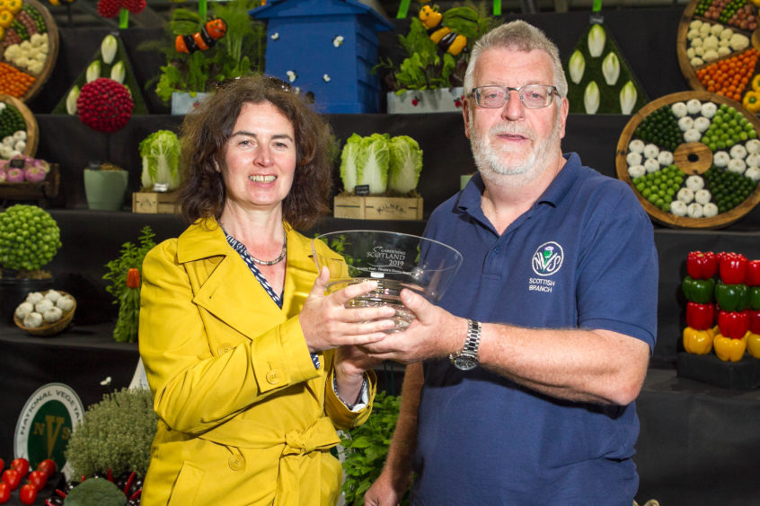 Chairman Ian Stock is presented with the award by Sunday Post gardening expert Agnes Stevenson