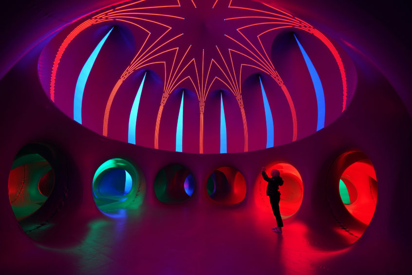 A woman takes a picture inside the Arboria Luminarium, a spectacular inflated light installation which will open tomorrow on the Salford Quays in Manchester