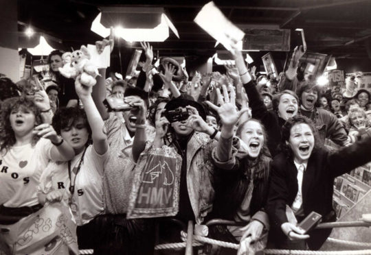 Fans of the pop group Bros in HMV music store awaiting the arrival of the boys fans screaming and shouting.