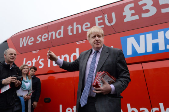 PM hopeful Boris Johnson in front of NHS bus