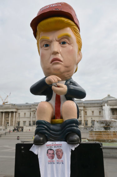 A 16ft talking robot of US President Donald Trump sitting on a gold toilet in Trafalgar Square