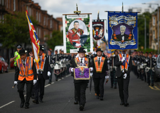 Members of the Orange Order take part in the Glasgow parade