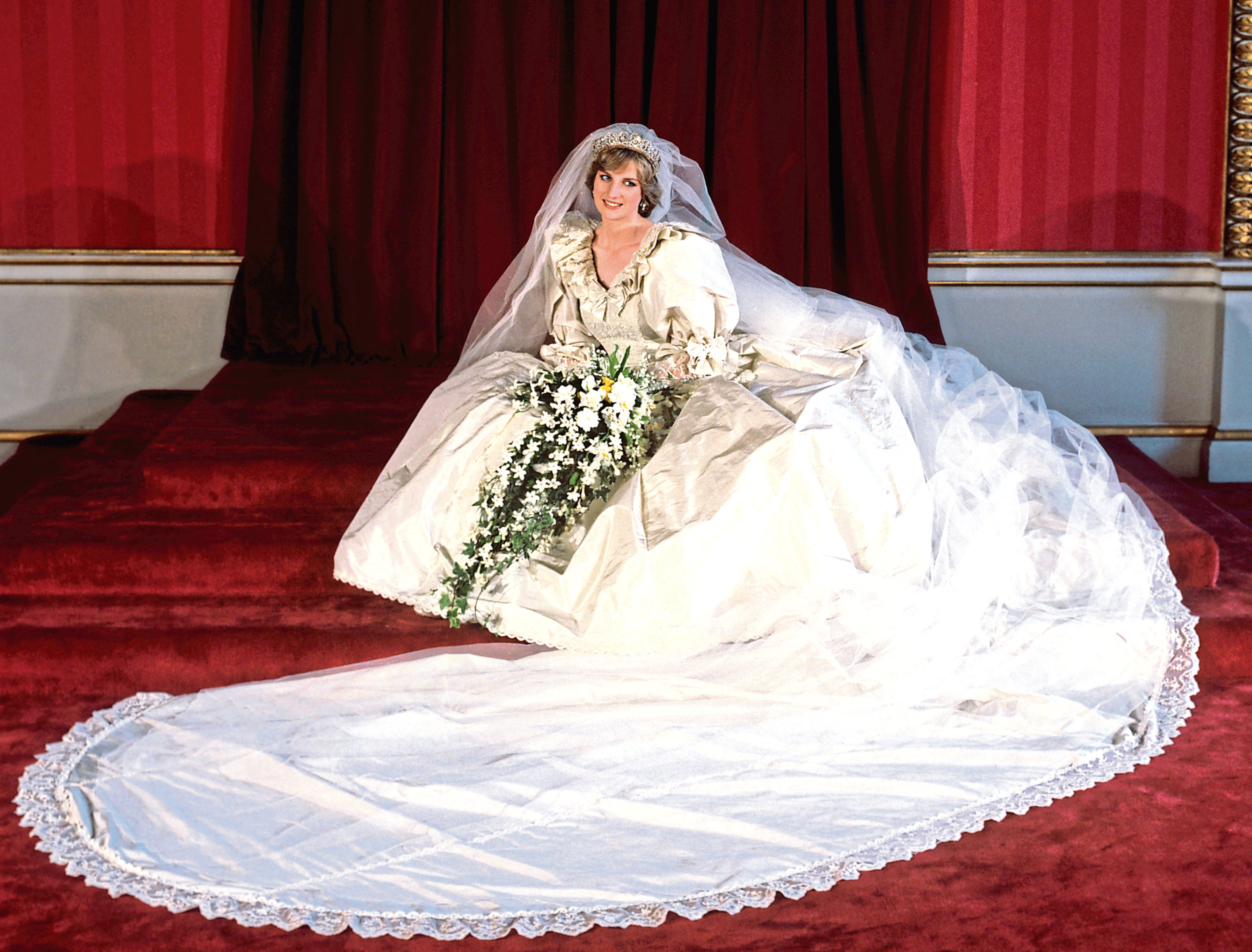 The Princess of Wales seated in her bridal gown at Buckingham Palace after her marriage to Prince Charles at St. Paul's Cathedral.